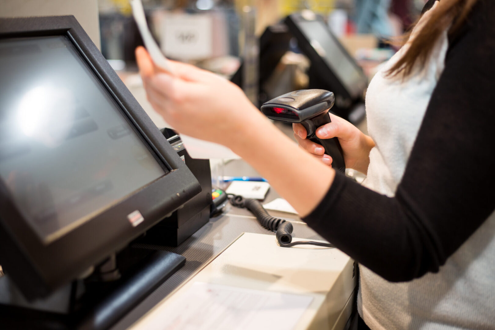 Young woman hand doing process payment on a touchscreen cash register, finance concept